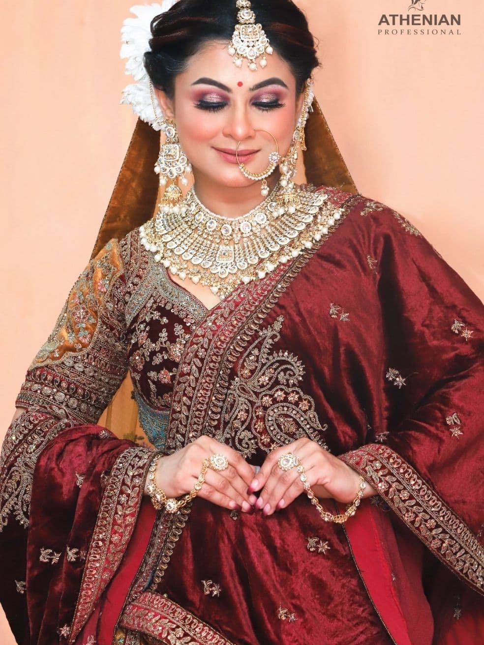 Bridal makeup and styling in gold and maroon